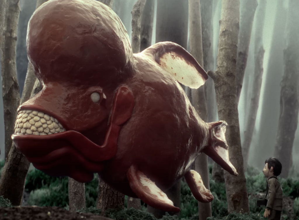 giant fish in the woods with a boy staring at it